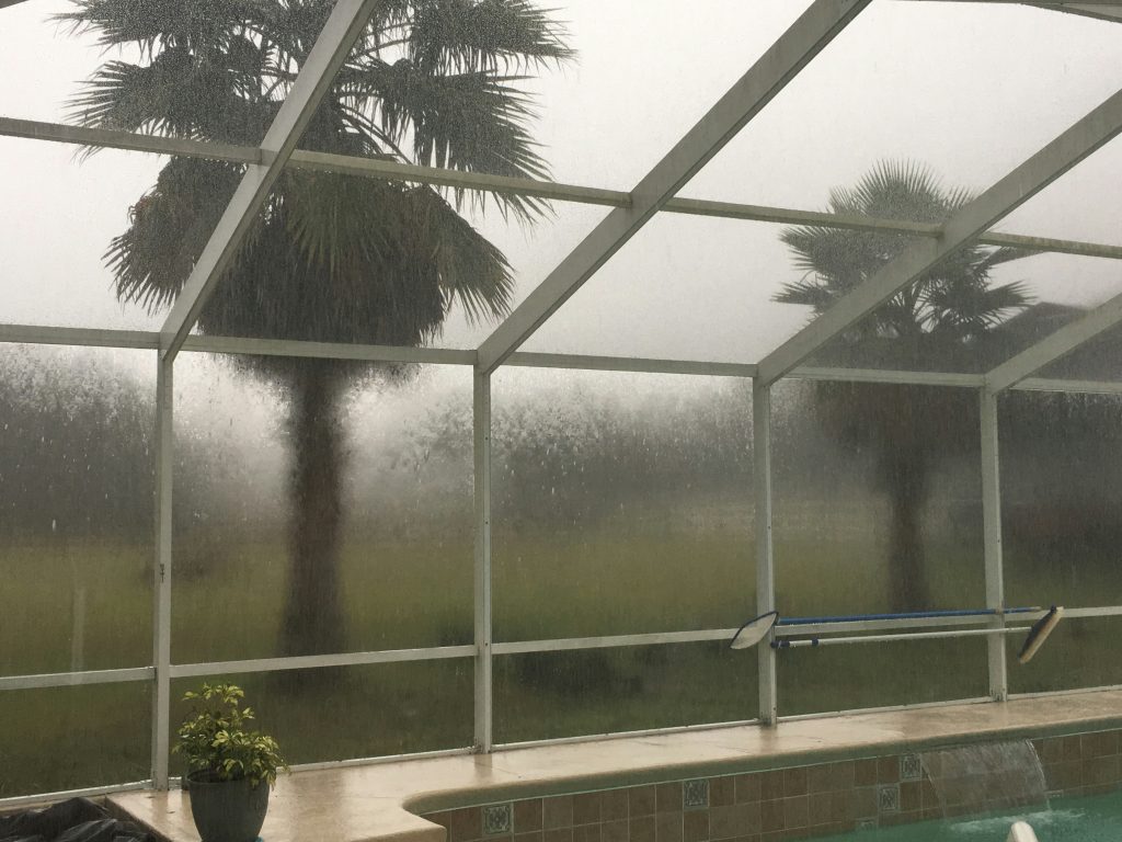 Screen enclosure over pool during storm